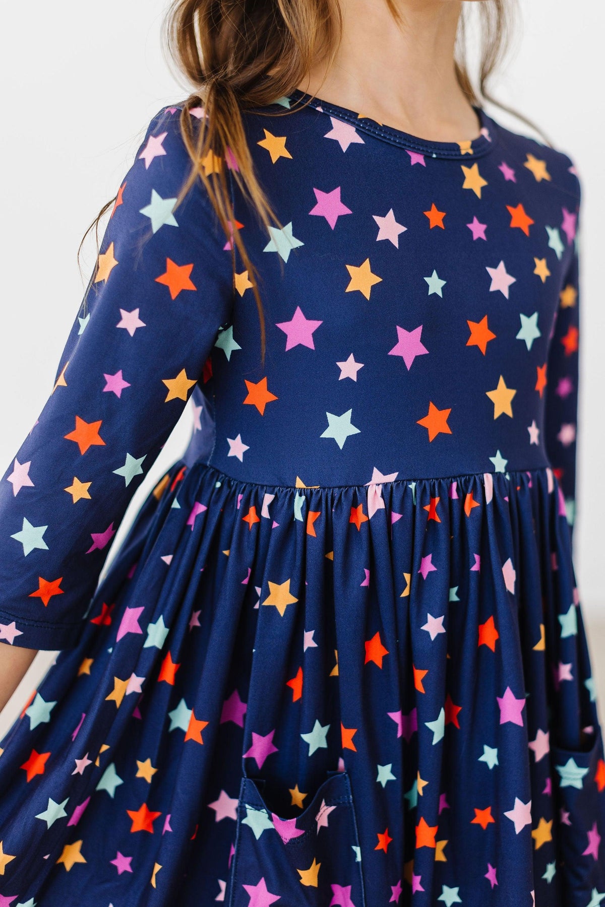 a child wearing a dress with stars on it