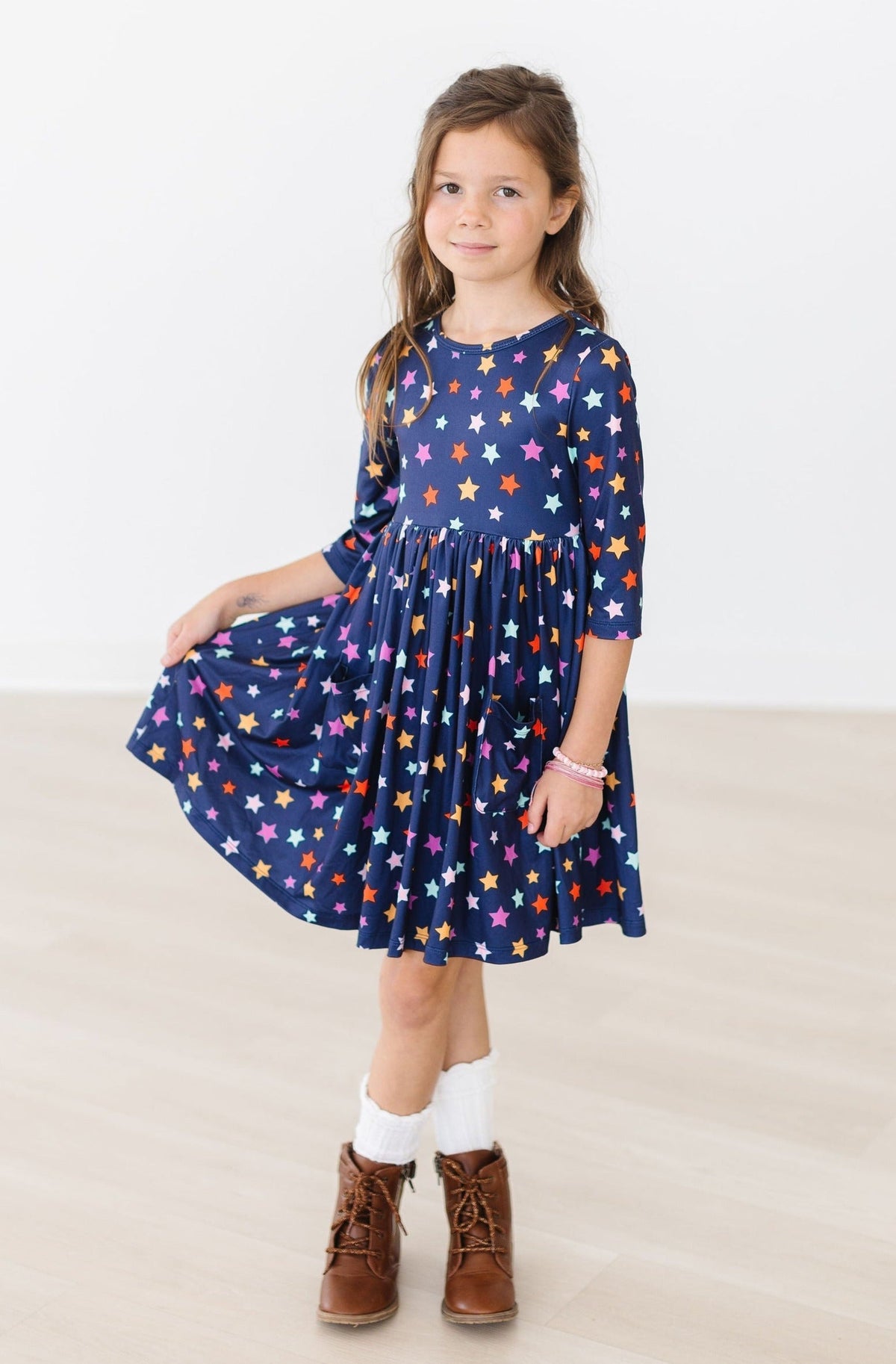 a girl in a blue dress with stars on it