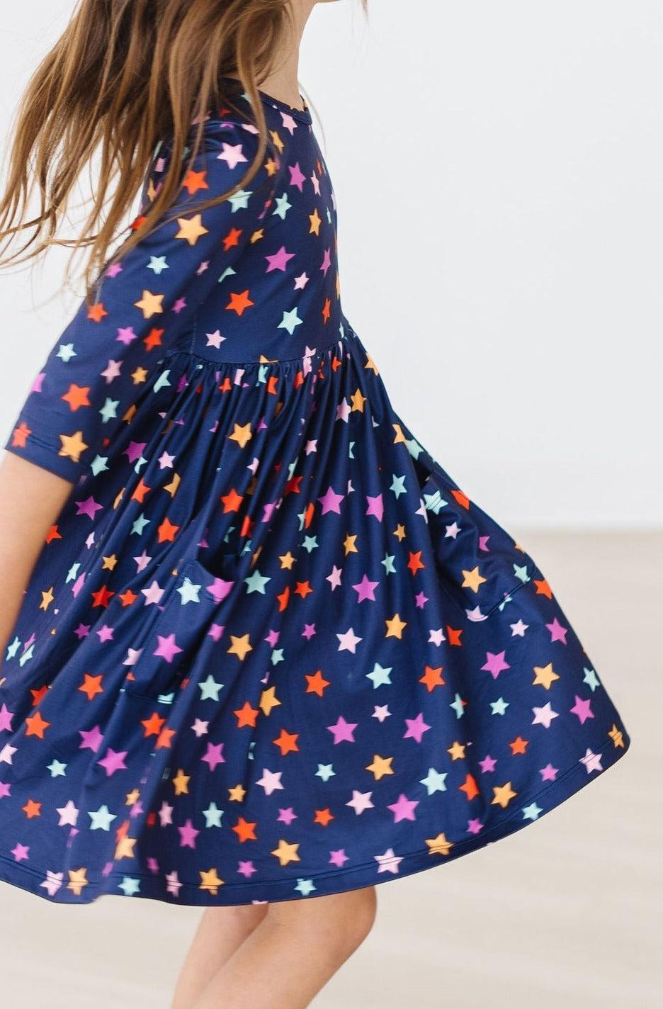 a girl wearing a blue dress with stars on it