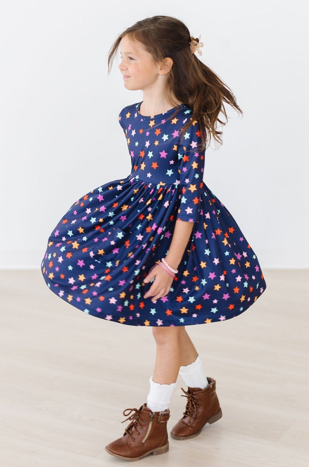 a girl in a blue dress with stars on it