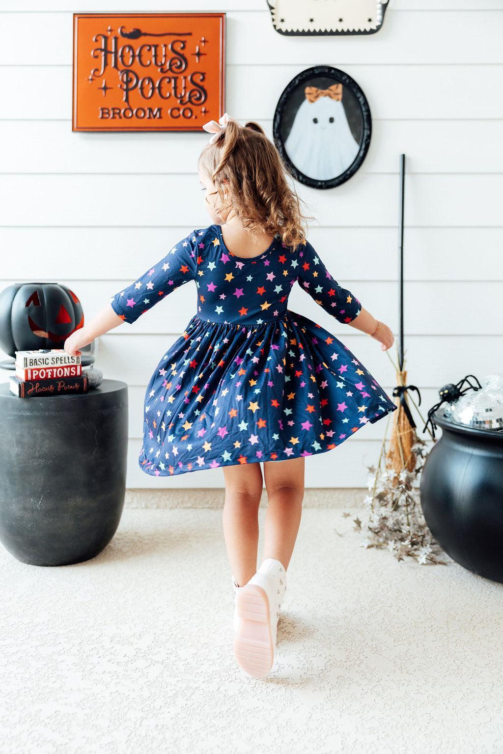 a girl in a blue dress with stars on her head