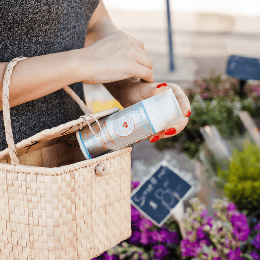 a woman holding a basket with a spray can