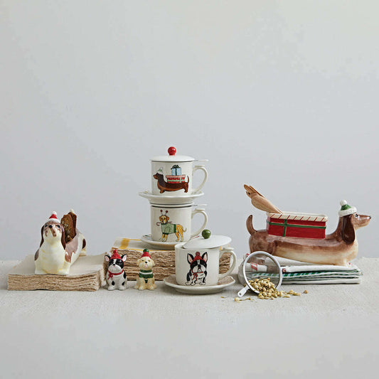 a group of teacups and saucers with dog figurines