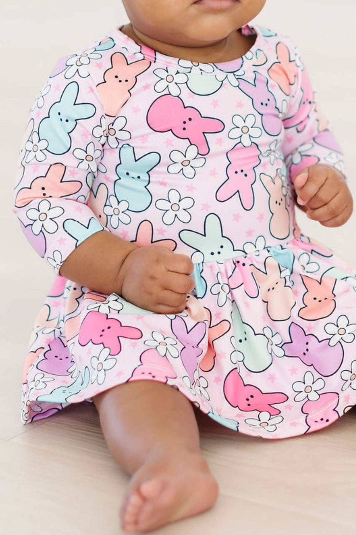 a baby wearing a dress with bunny designs