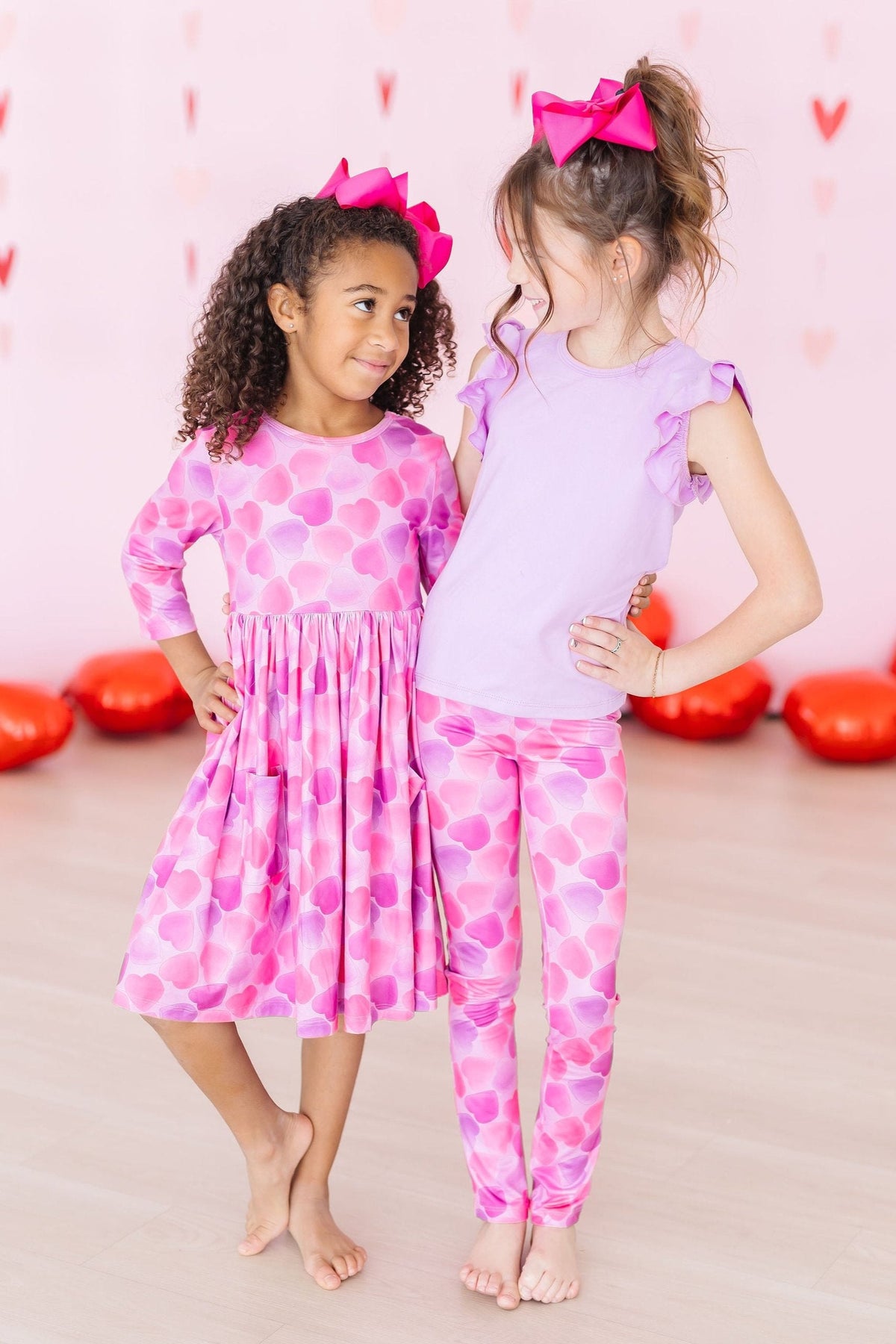 two girls in pink outfits