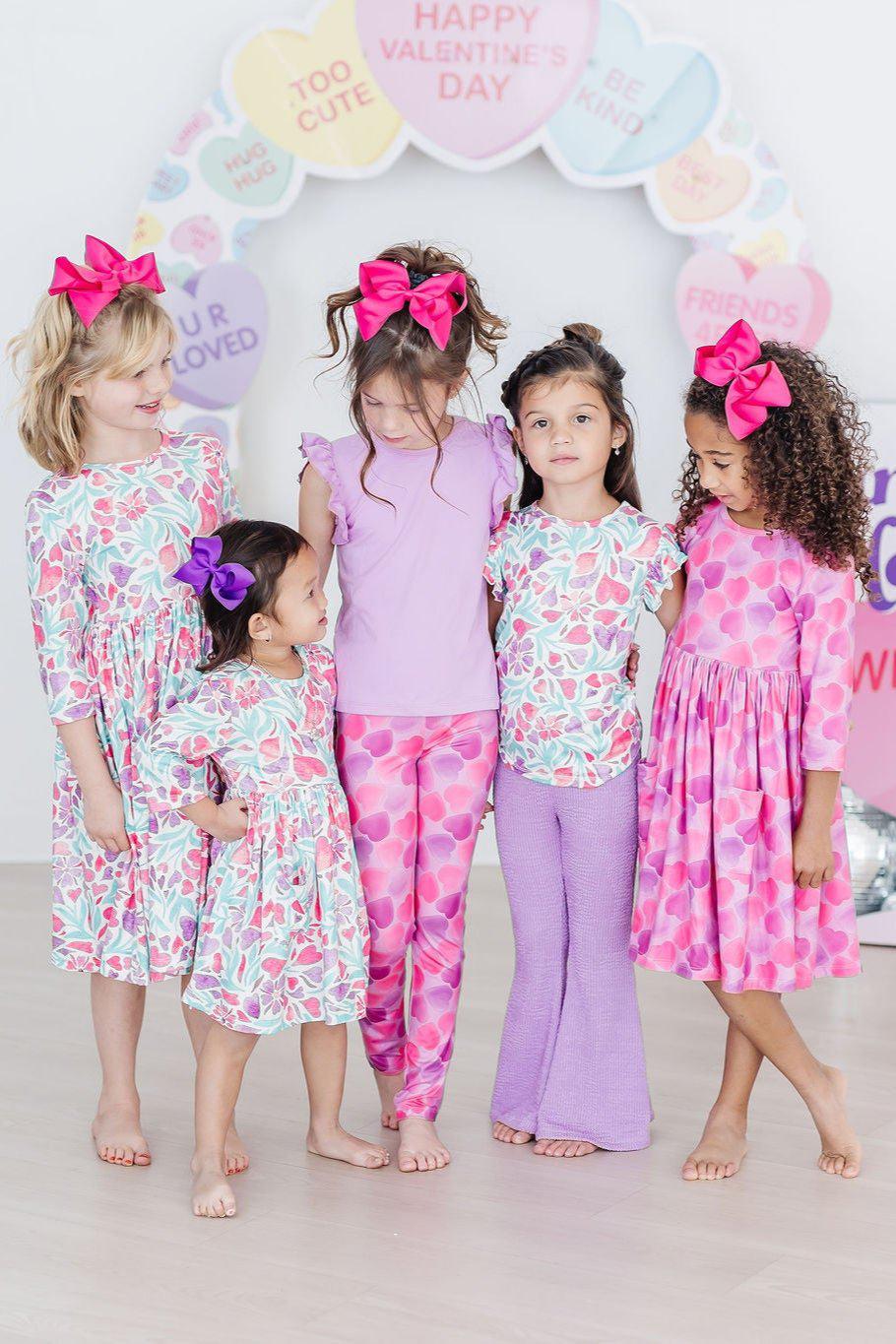 a group of girls wearing matching outfits