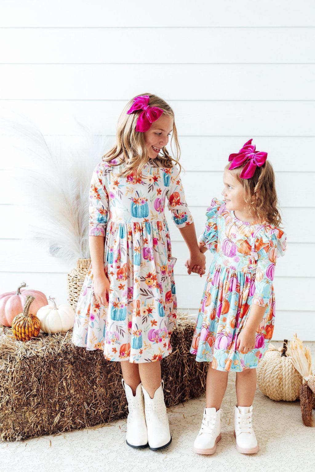 two girls holding hands and smiling