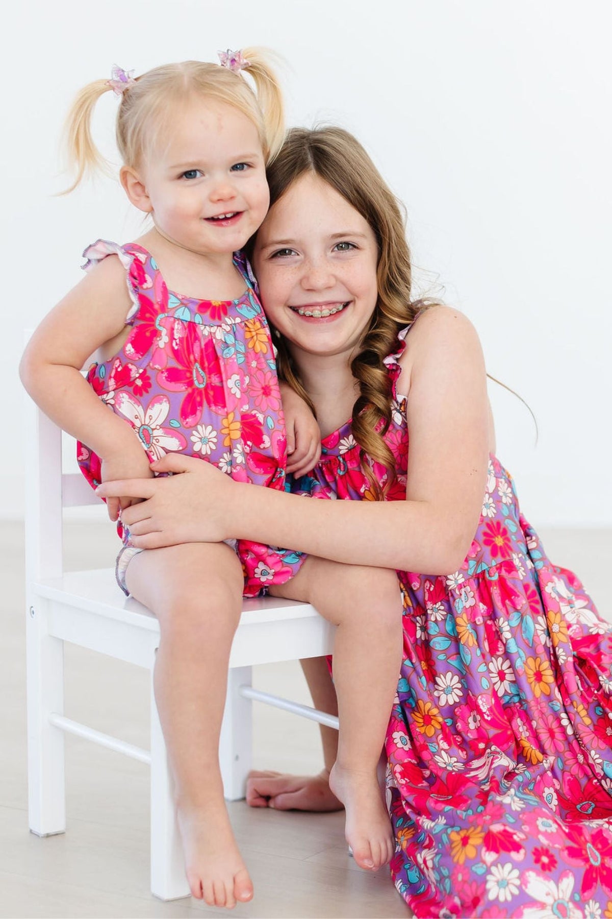 two girls sitting on a chair