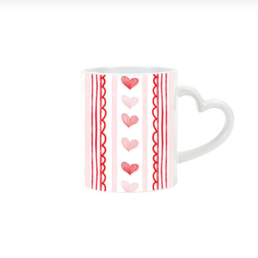 a white mug with red hearts on it