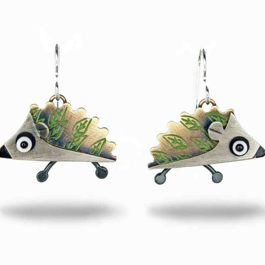 a pair of earrings with a hedgehog shaped object
