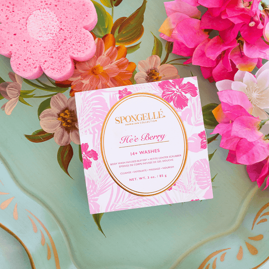 a pink and white flowered tray with a pink sponge and flowers