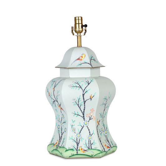 a white lamp with a gold lamp shade
