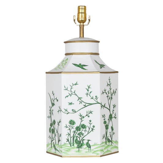a white and green vase with a gold lamp