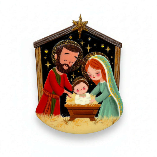 a christmas ornament with a picture of a manger and a baby