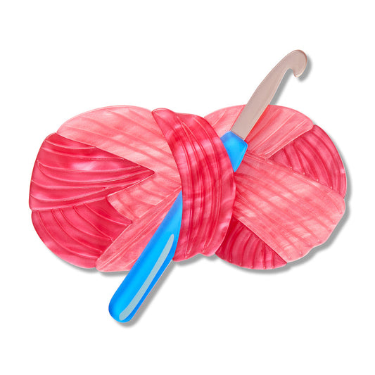 a pink yarn with a crochet hook