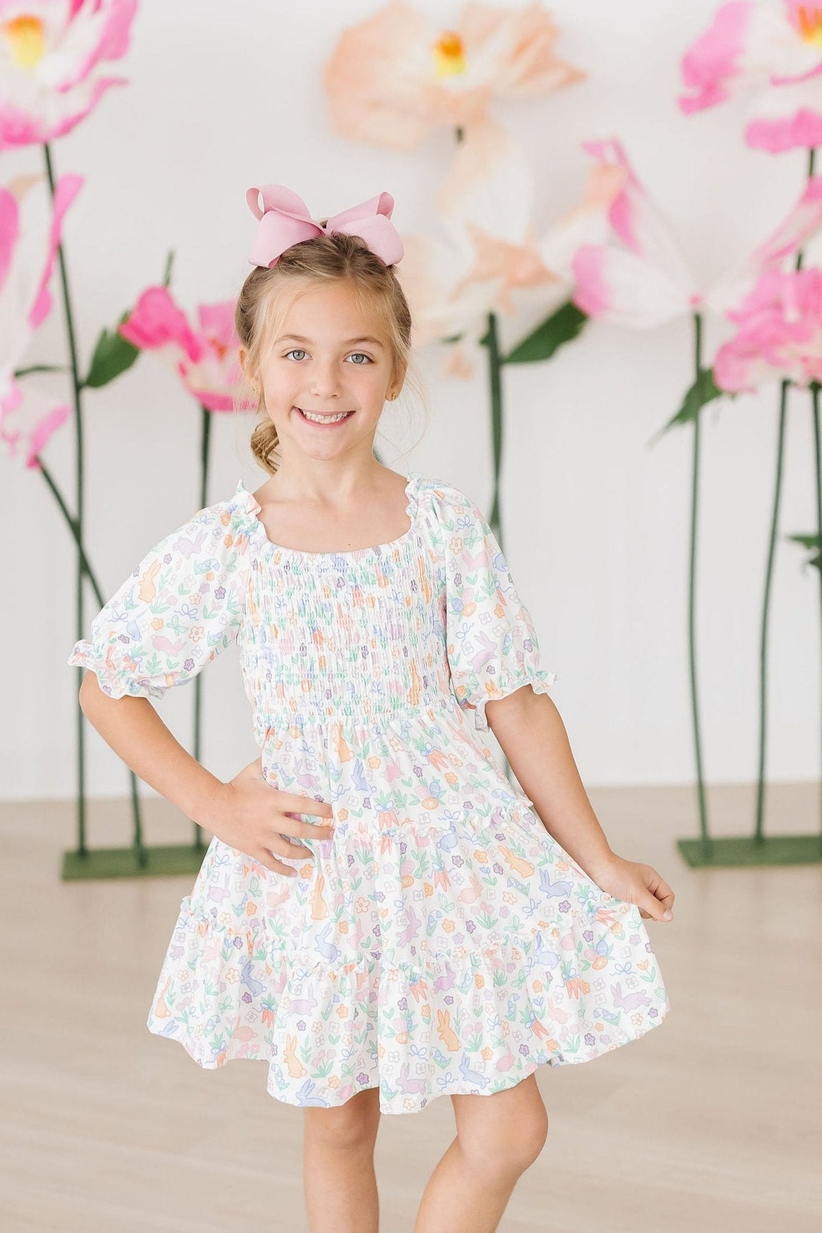 a girl in a dress with a bow