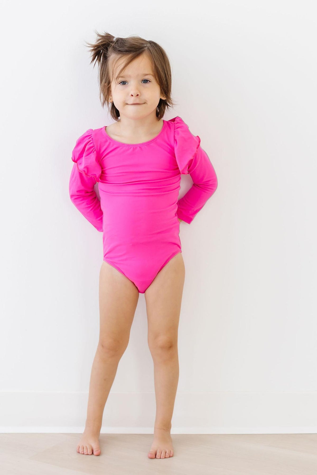 a girl in a pink leotard
