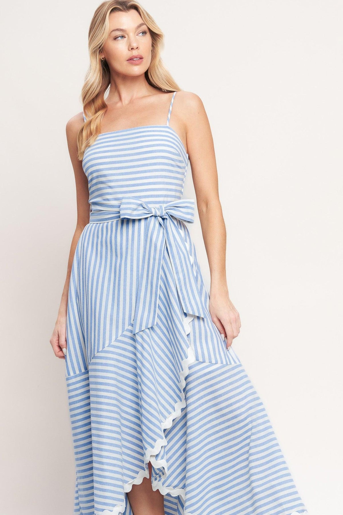 a woman in a blue and white striped dress