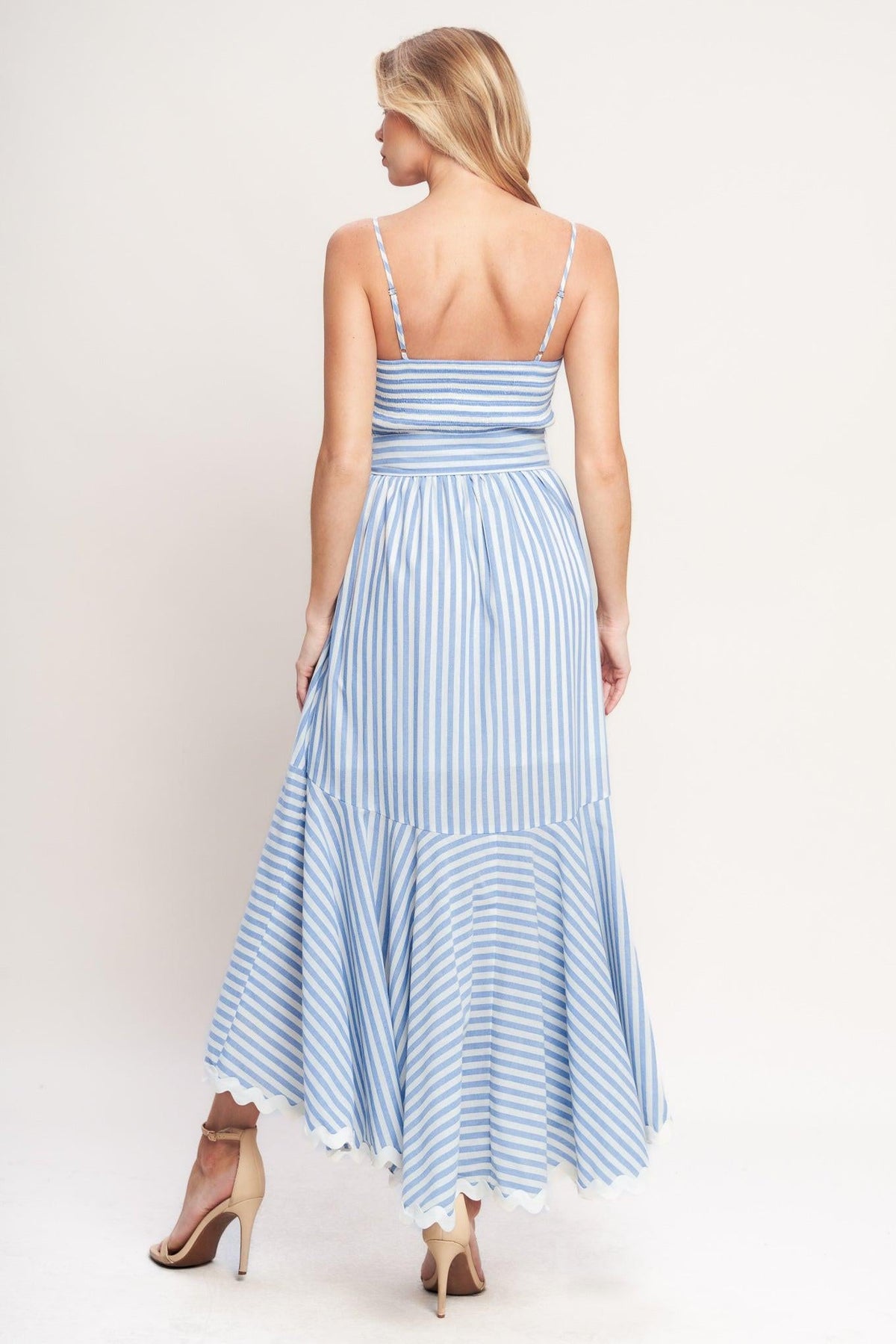 a woman in a blue and white striped dress