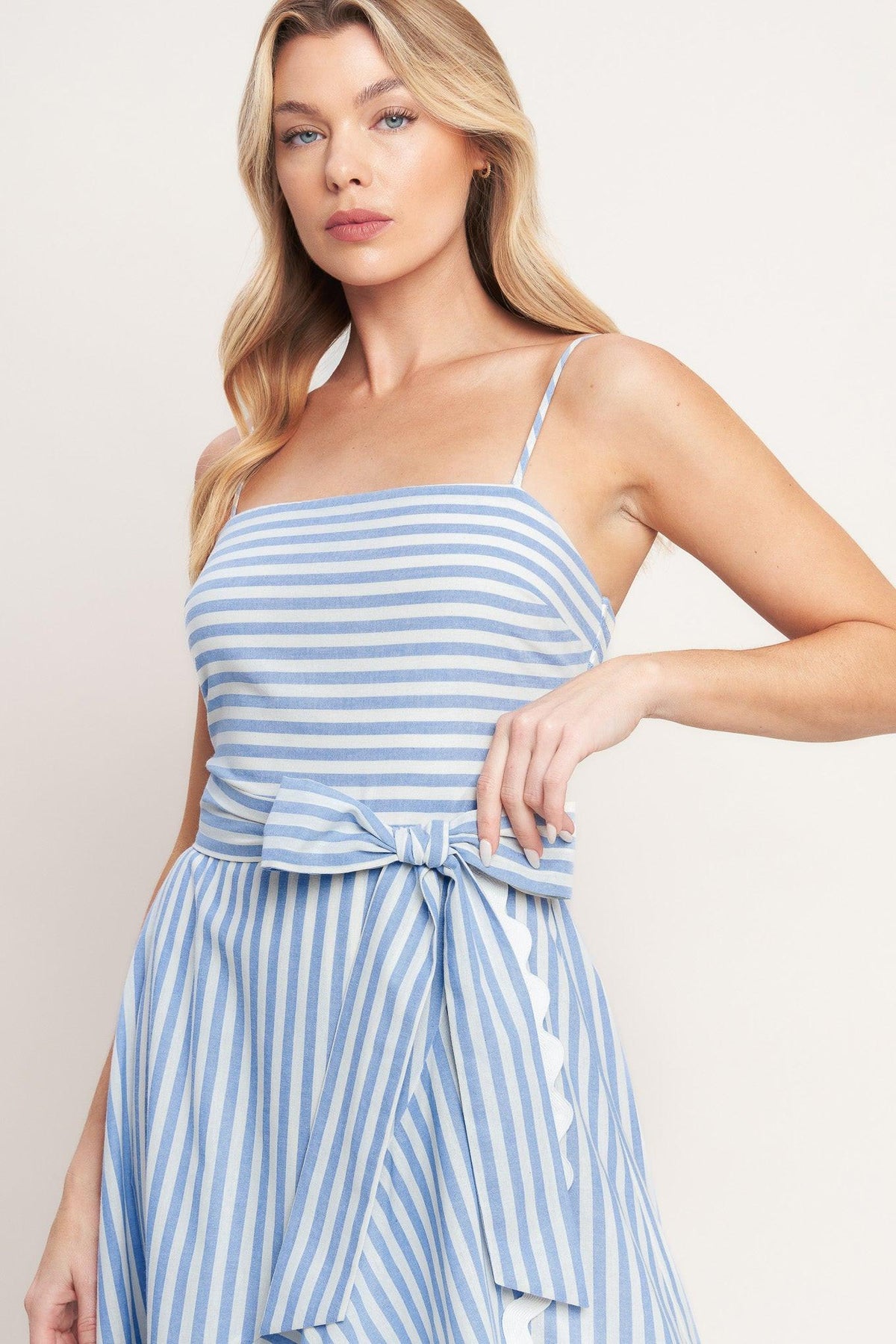 a woman in a blue and white striped dress