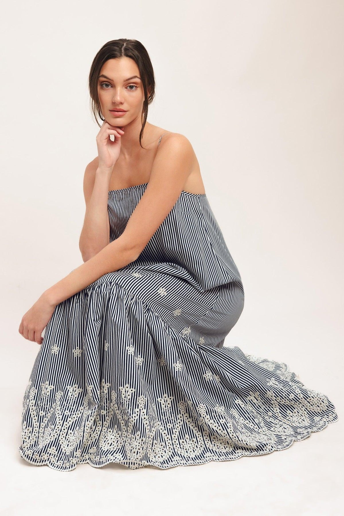 a woman in a striped dress