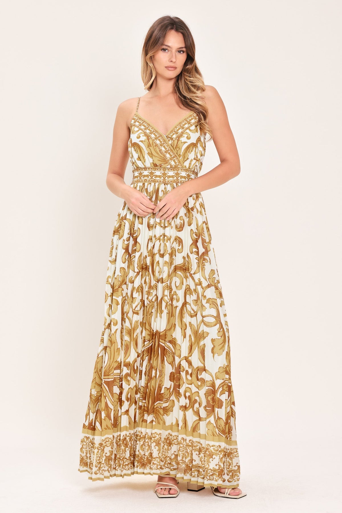 a woman in a white and gold dress