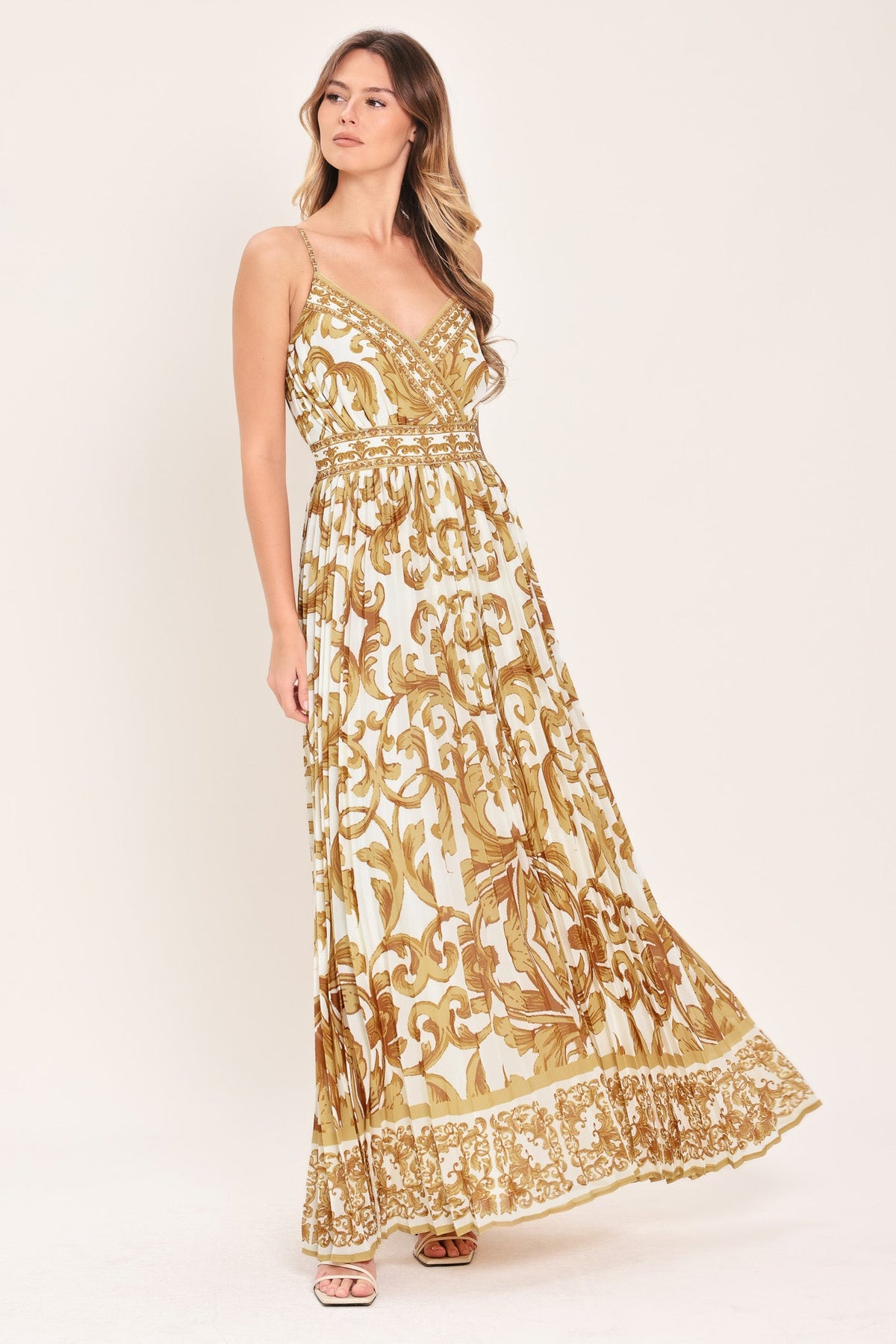 a woman in a white and gold dress
