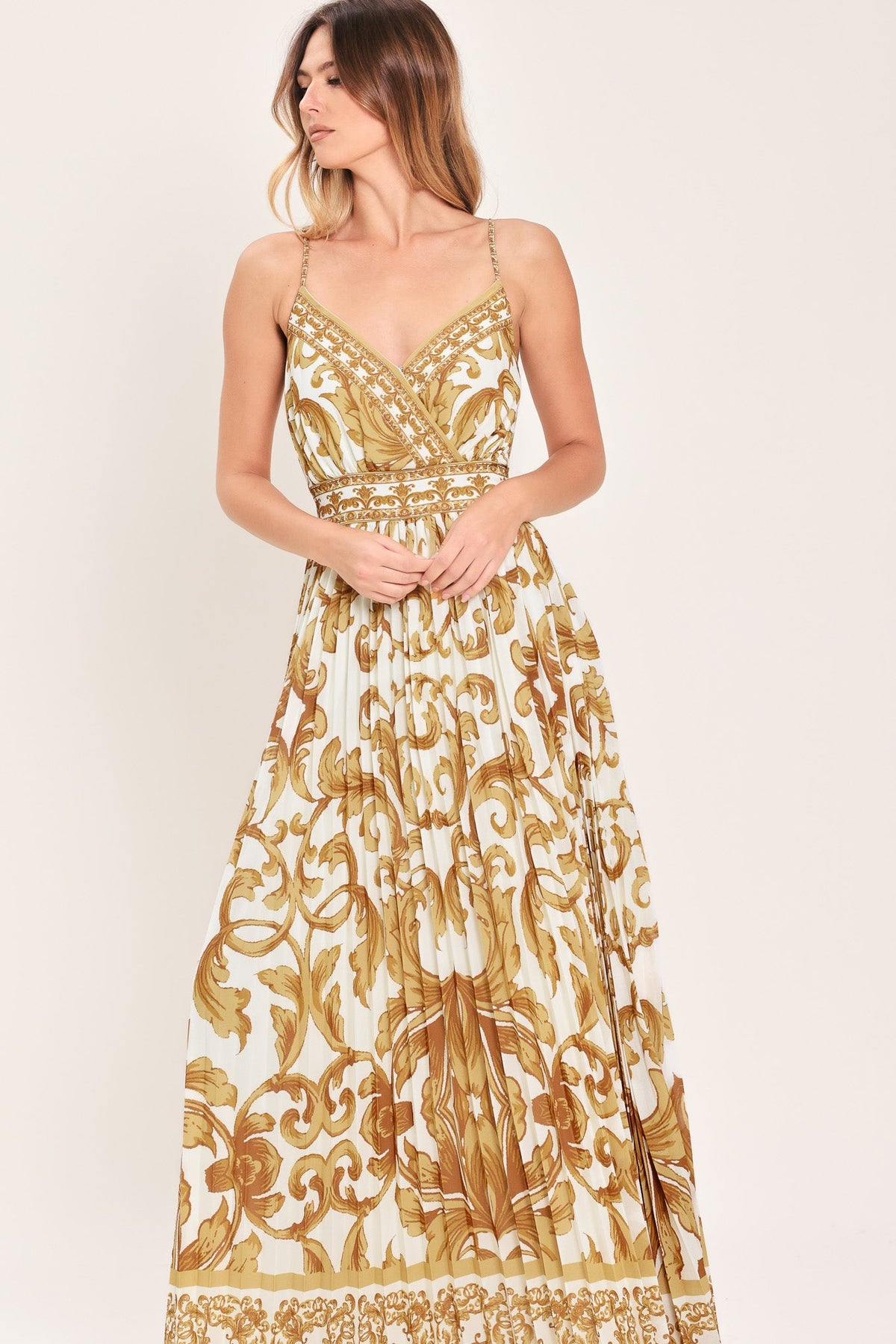 a woman in a white and gold dress