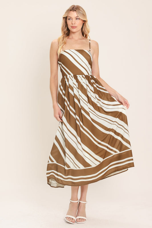 a woman in a brown and white striped dress