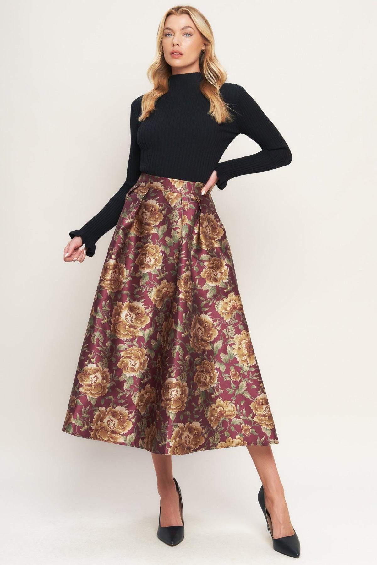 a woman in a floral skirt