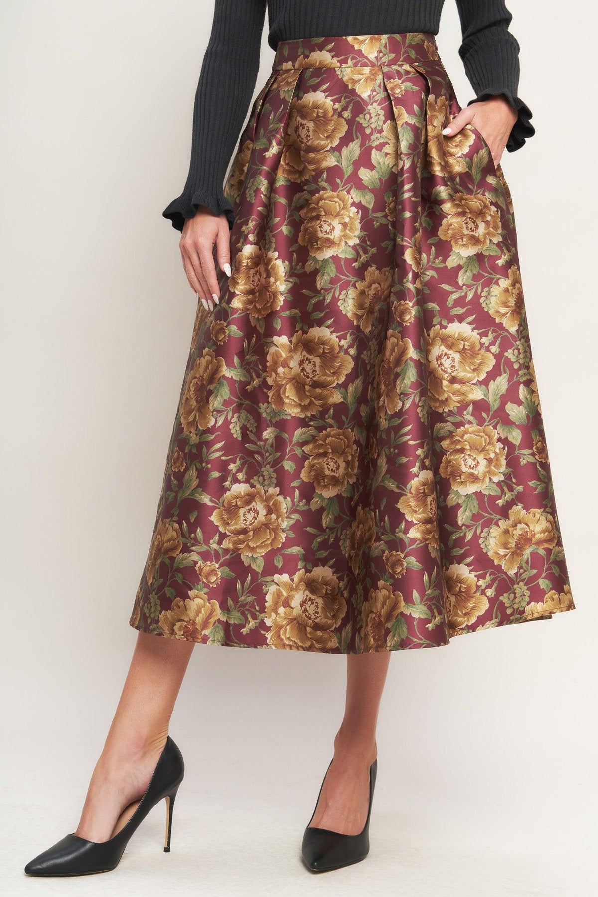 a woman wearing a floral skirt