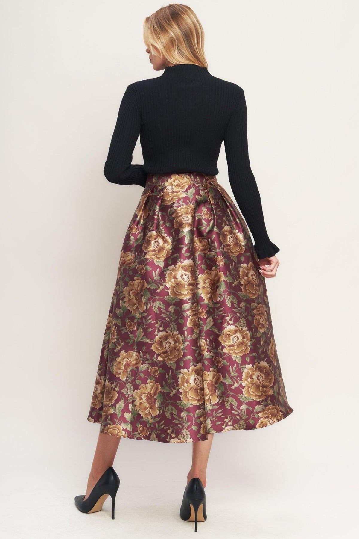 a woman in a floral skirt