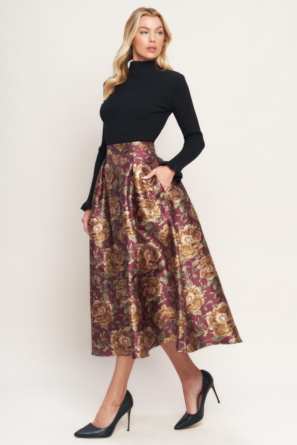 a woman in a floral skirt
