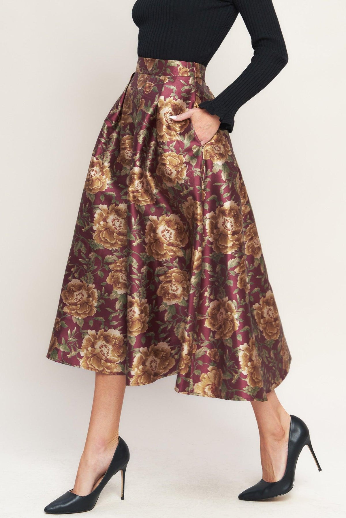 a woman wearing a floral skirt