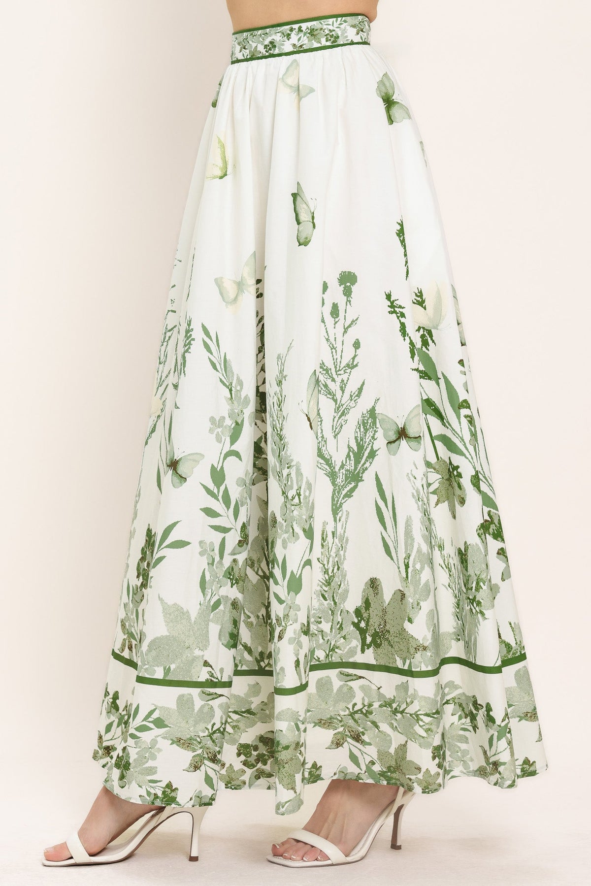 a white skirt with green butterflies and flowers