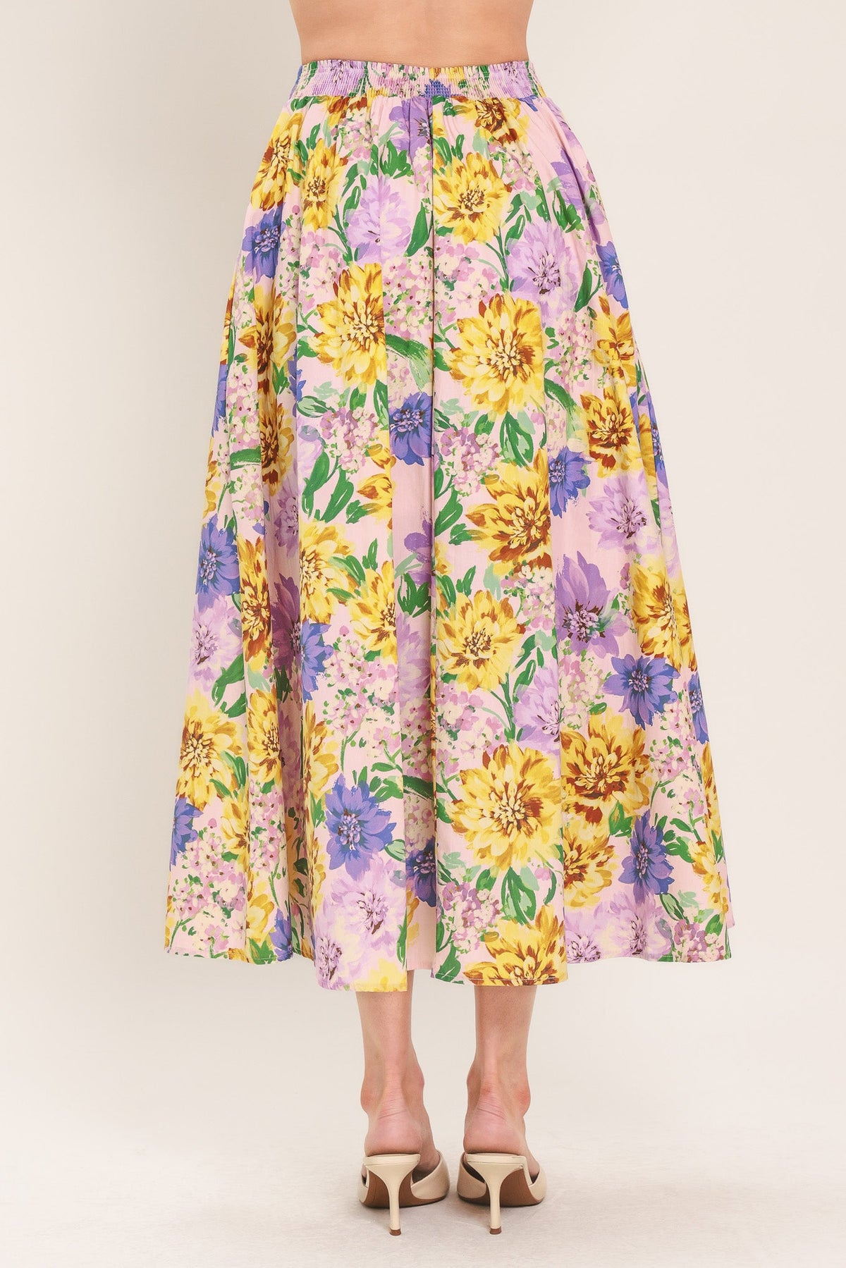 a woman wearing a floral skirt