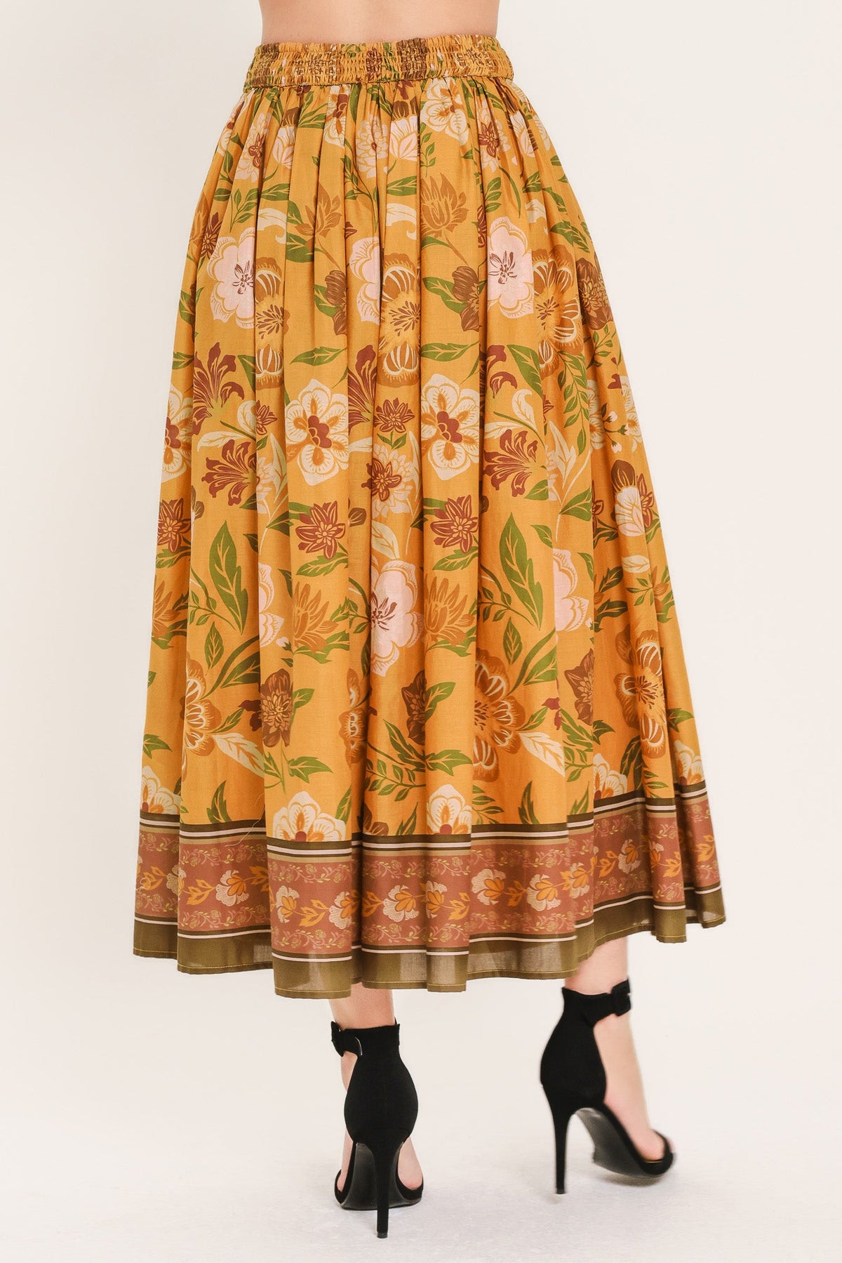 a woman wearing a floral skirt