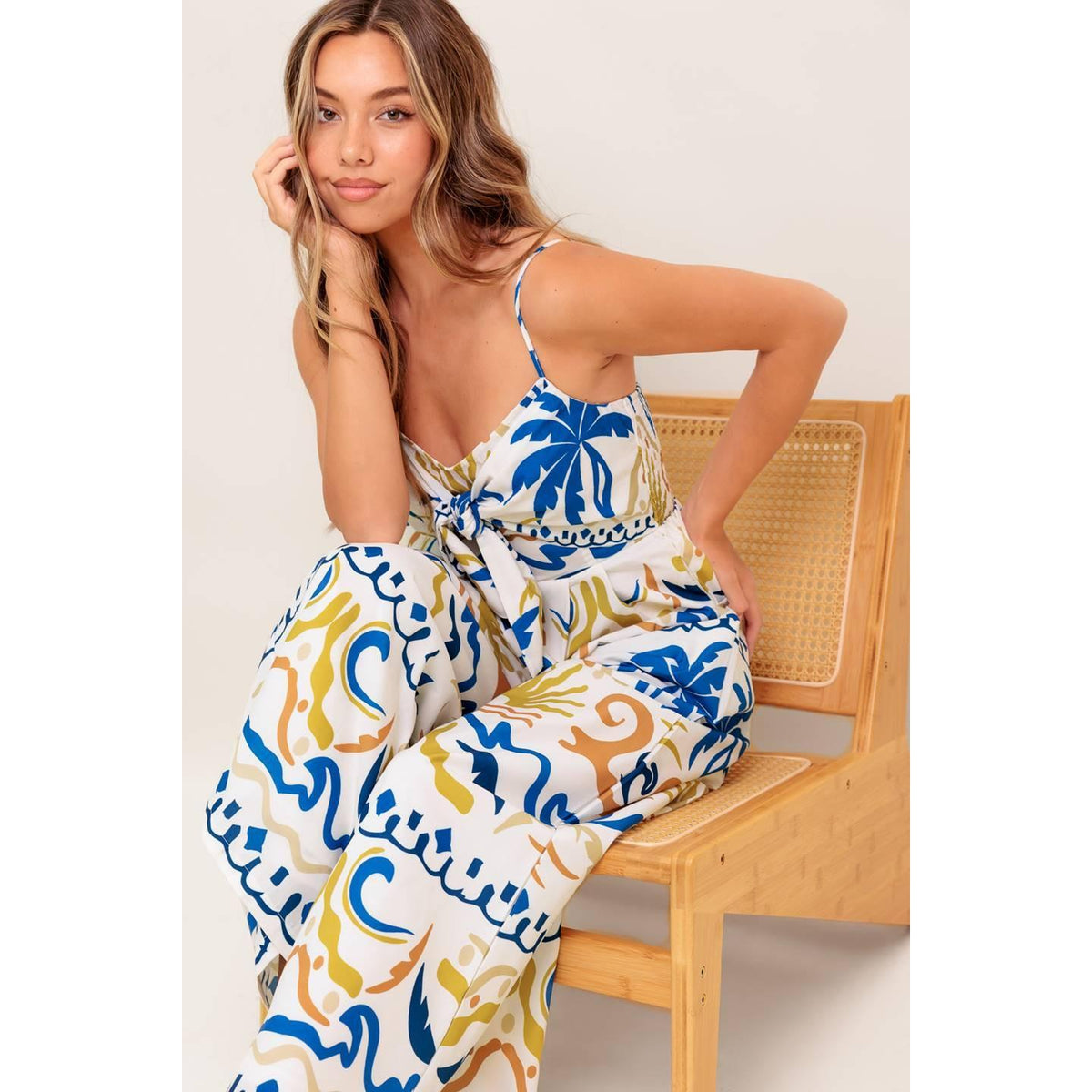 a woman in a dress sitting on a chair