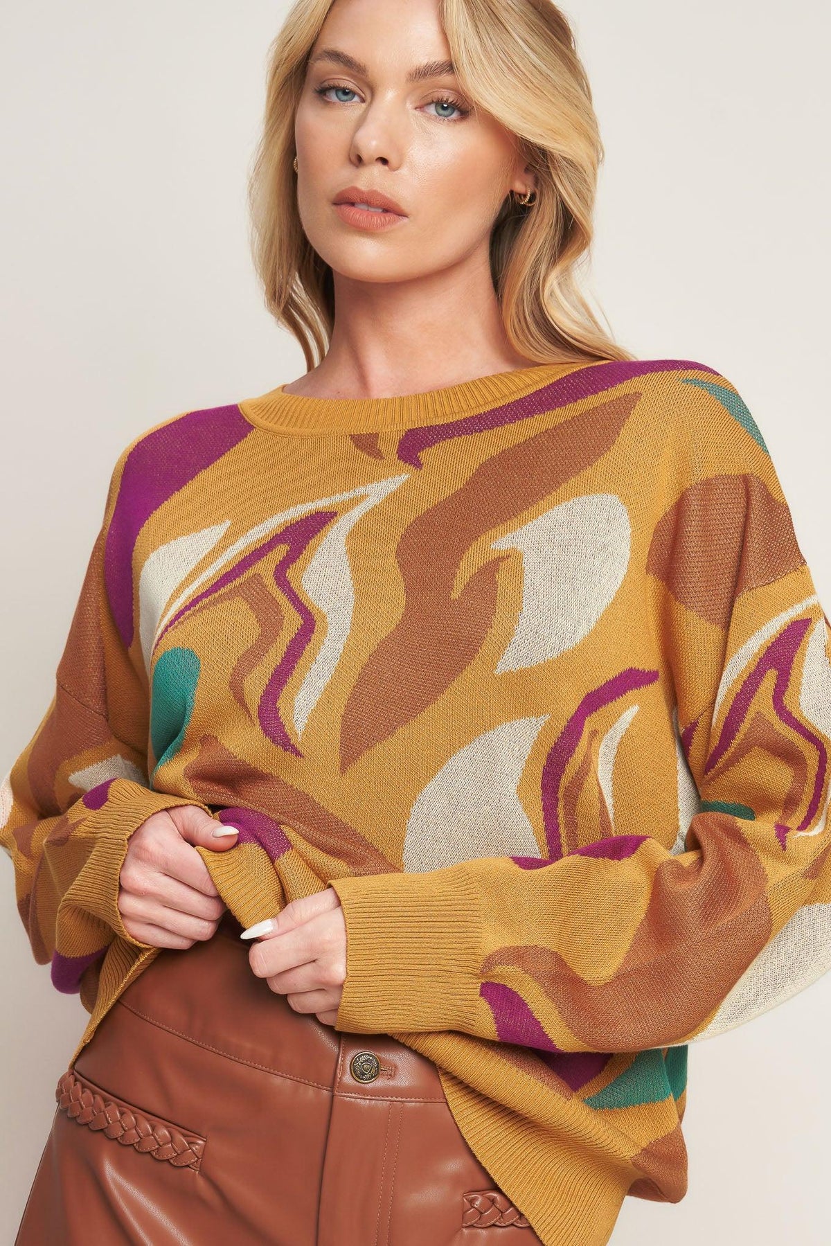 a woman wearing a sweater and sunglasses