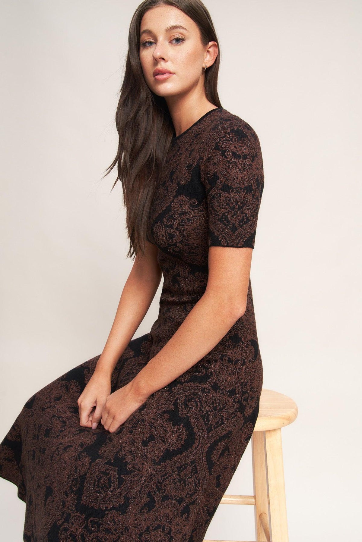 a woman sitting on a stool