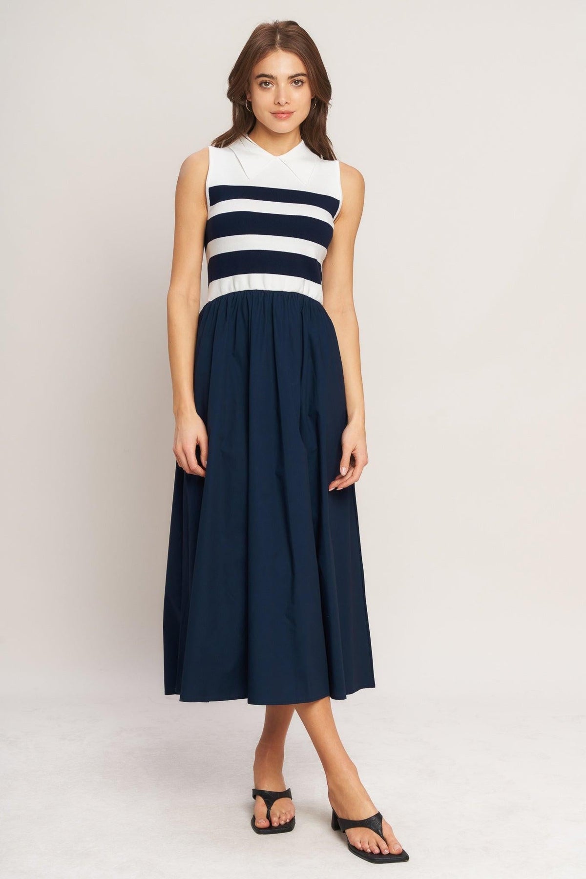 a woman in a blue and white striped dress