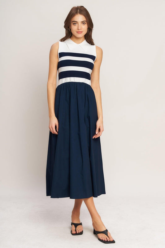 a woman in a blue and white striped dress