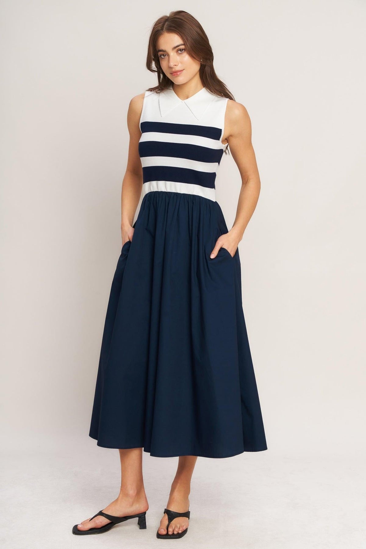 a woman in a blue and white striped dress