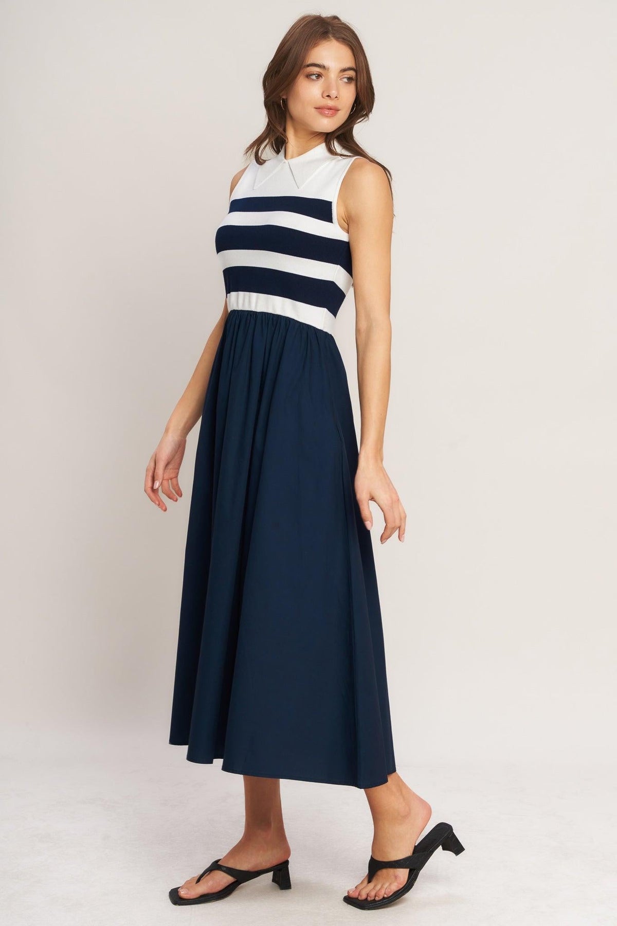 a woman in a blue and white striped dress