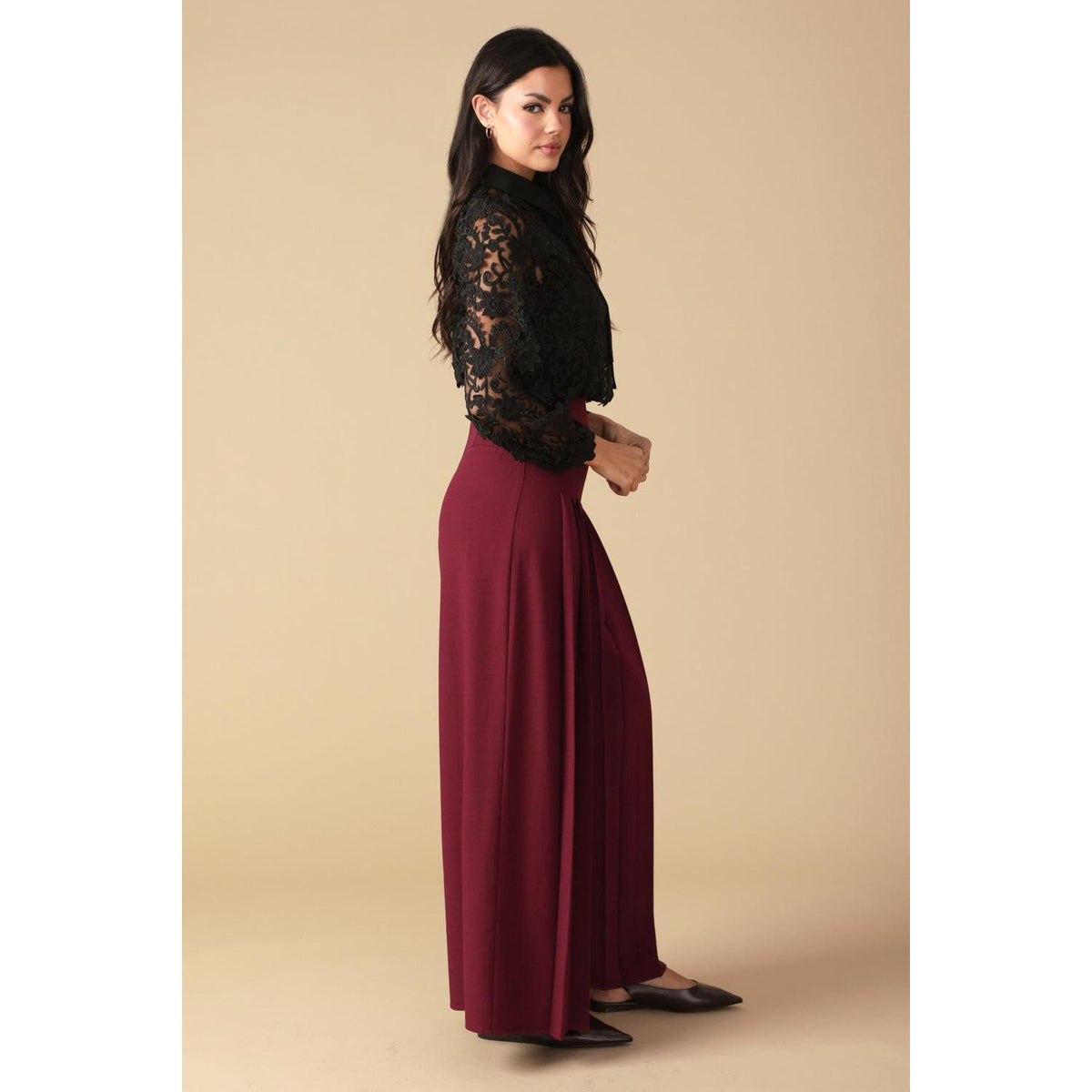 a woman in a black shirt and red skirt