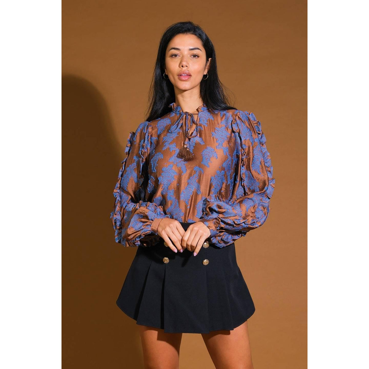 a woman in a brown and blue blouse