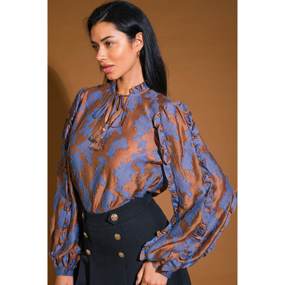 a woman in a brown and blue blouse