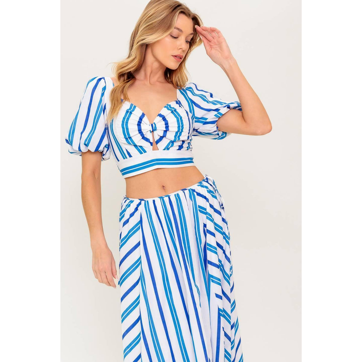 a woman in a blue and white striped dress