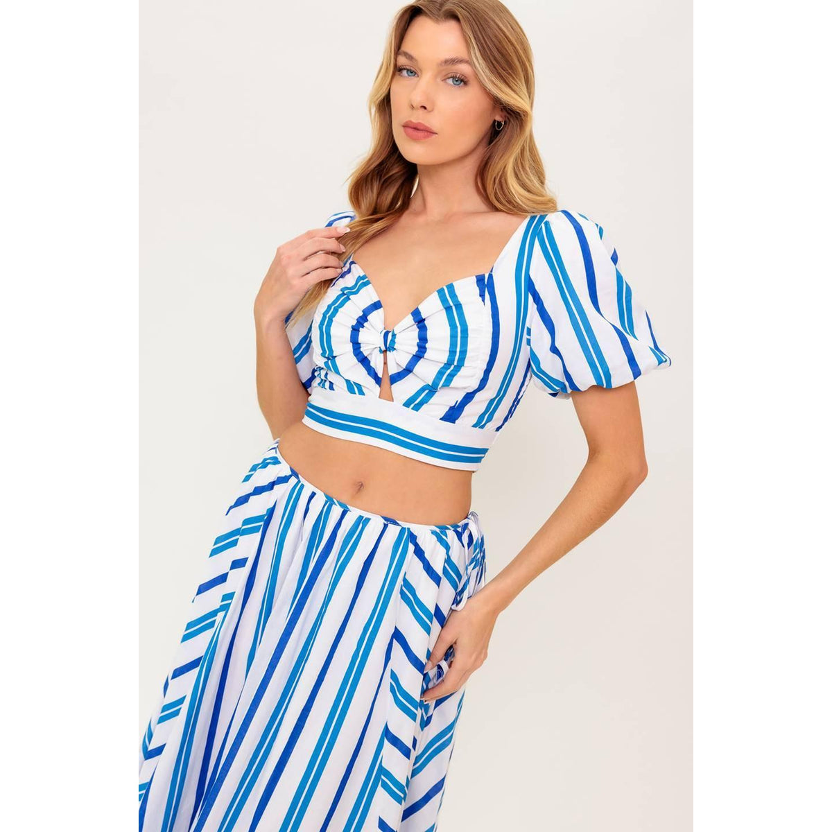 a woman in a blue and white striped dress