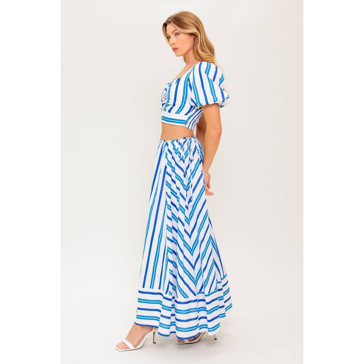 a woman in a blue and white striped dress